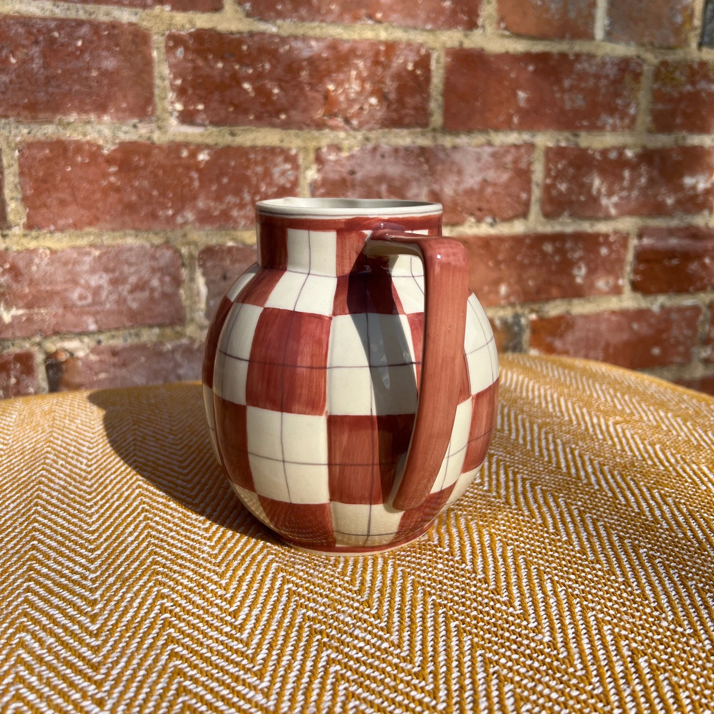 Checkered ceramic pitcher